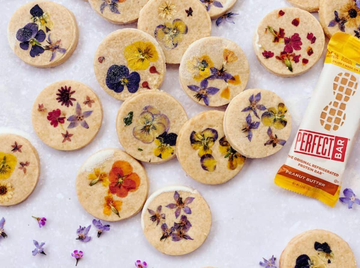 Delicious peanut butter shortbread cookies with pressed flowers on a tray.