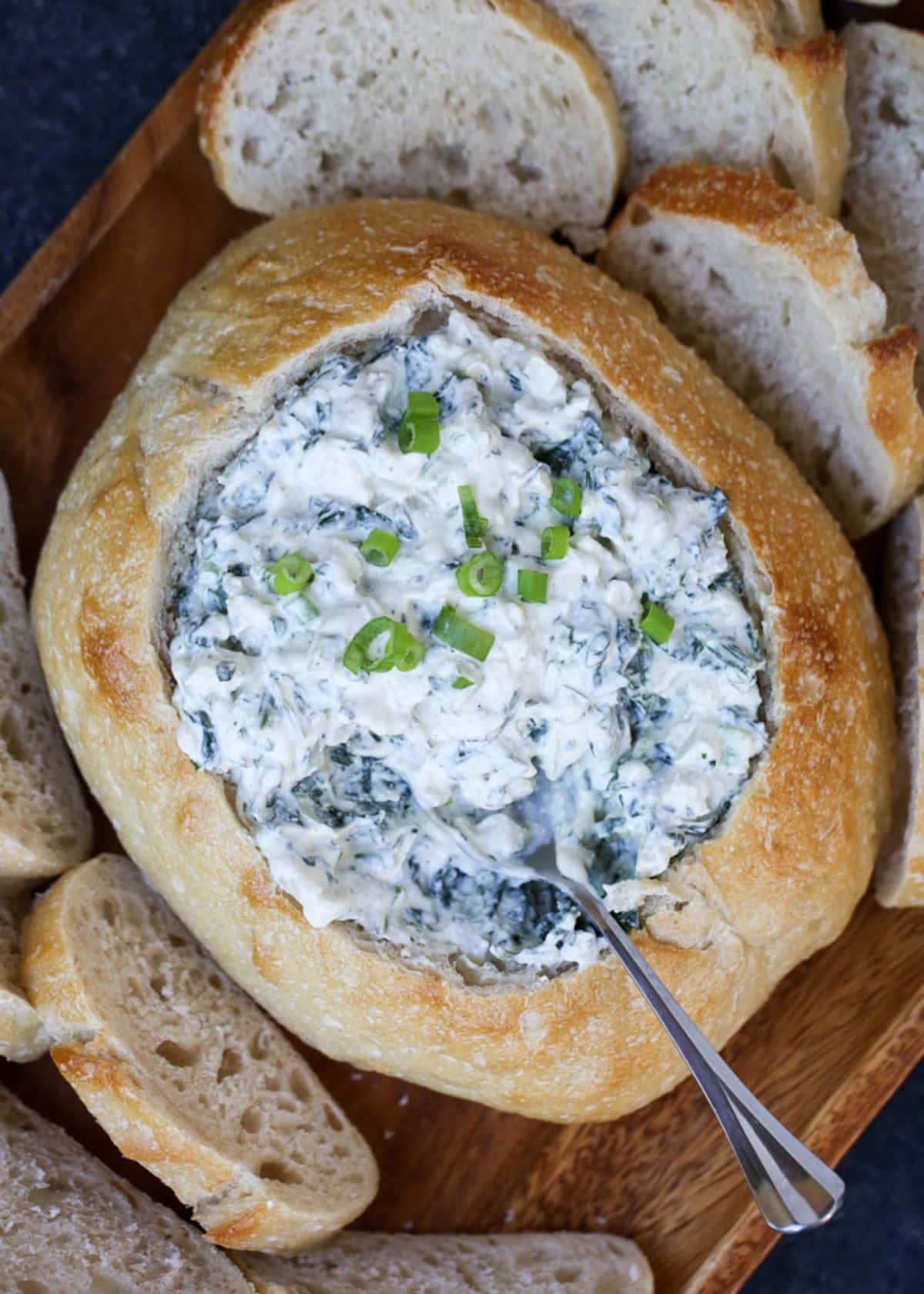 Creamy spinach dip with water chestnuts in a bread.
