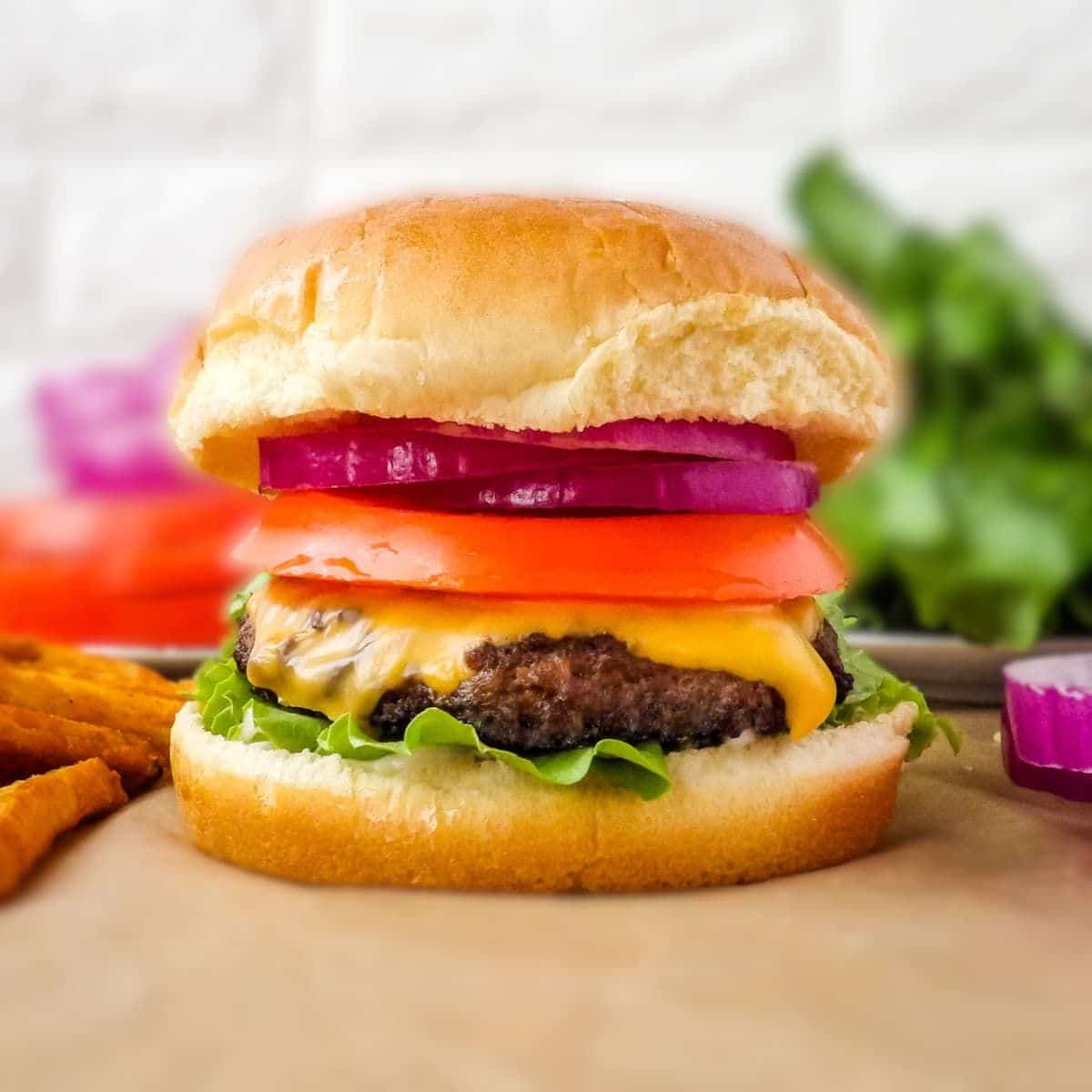 Tasty venison burgers on a table.