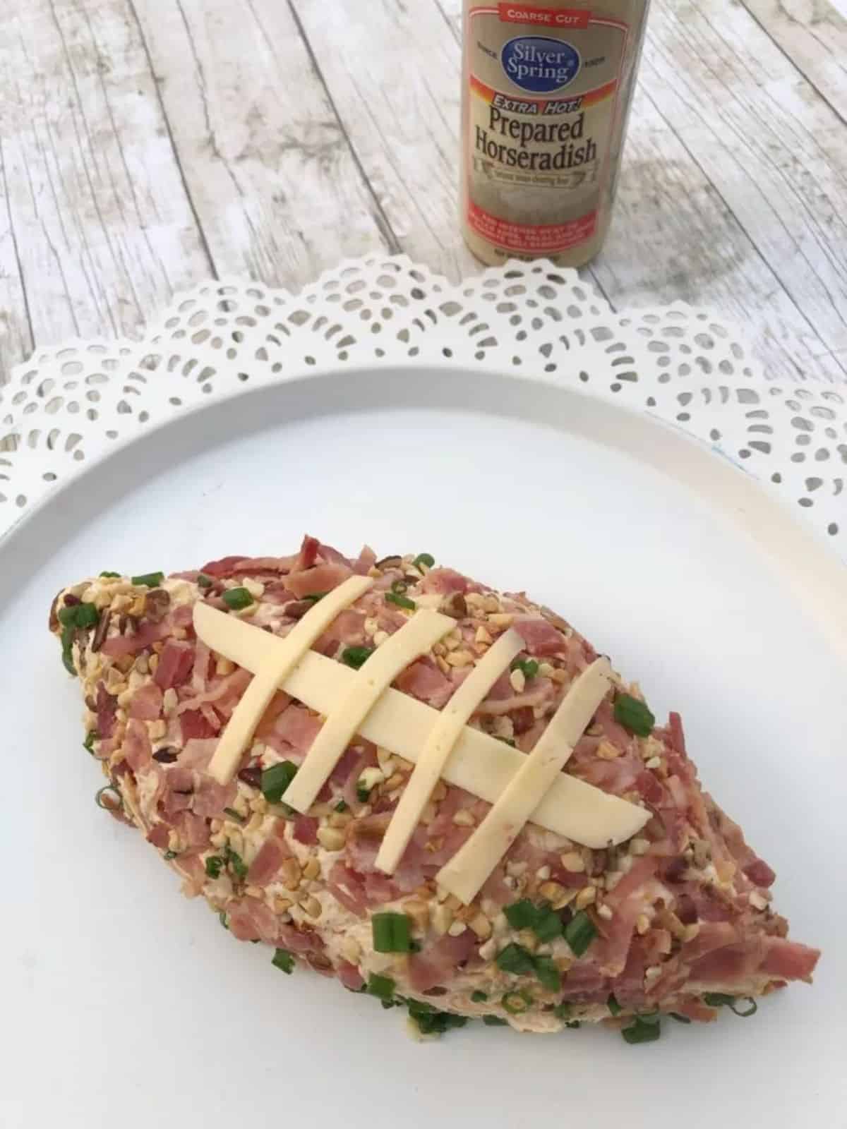 Scrumptious spicy cheese ball on a white plate.