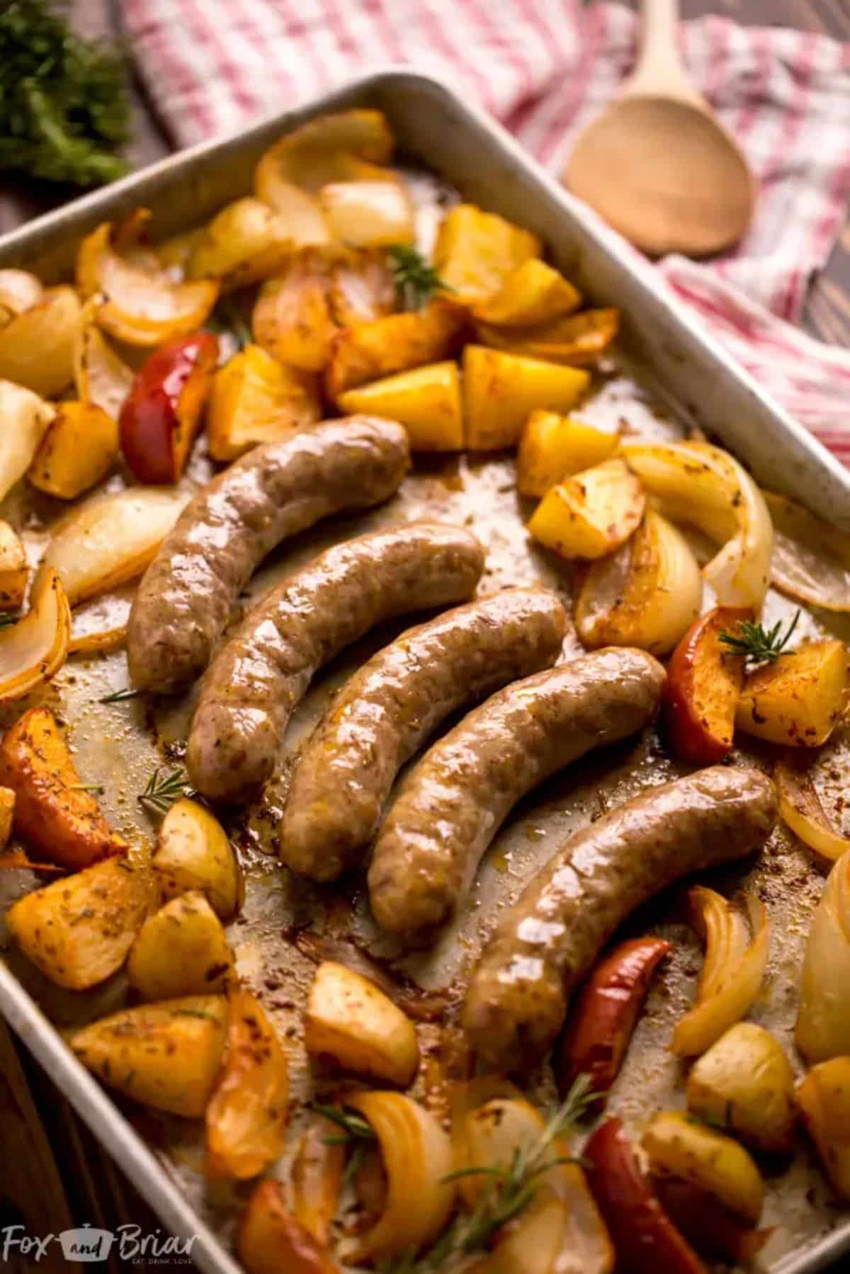 Delicious sausage and potatoes sheet pan dinner on a tray.