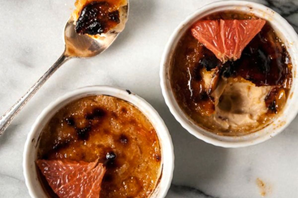 Mouth-watering grapefruit crème brûlée in two white bowls.
