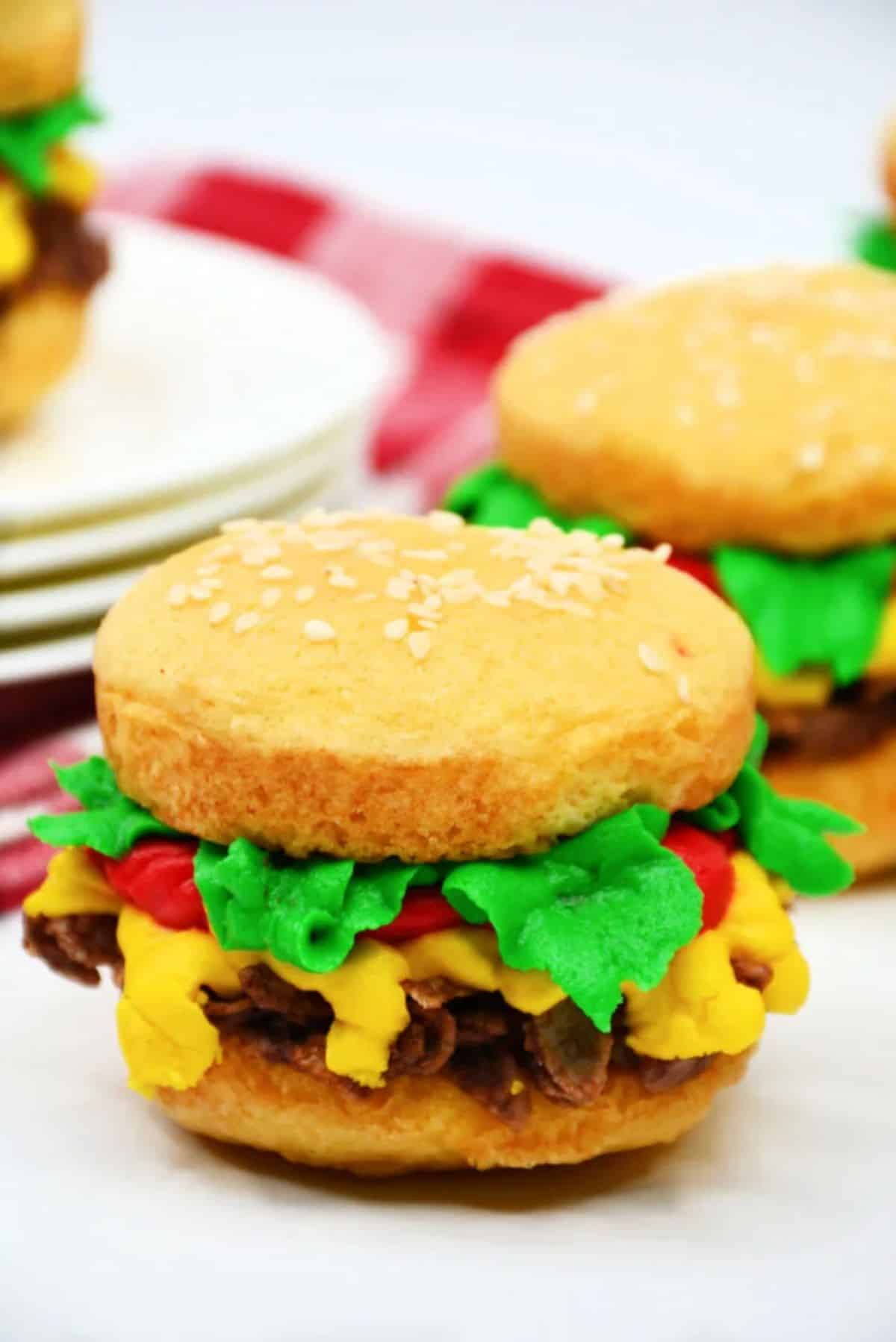 Flavorful cheeseburger whoopie pies on a countertop.