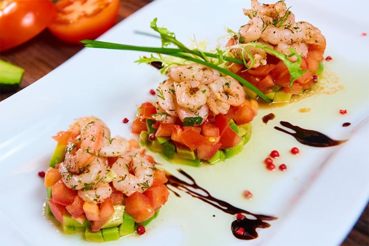Healthy stacked shrimp salad on a white tray.