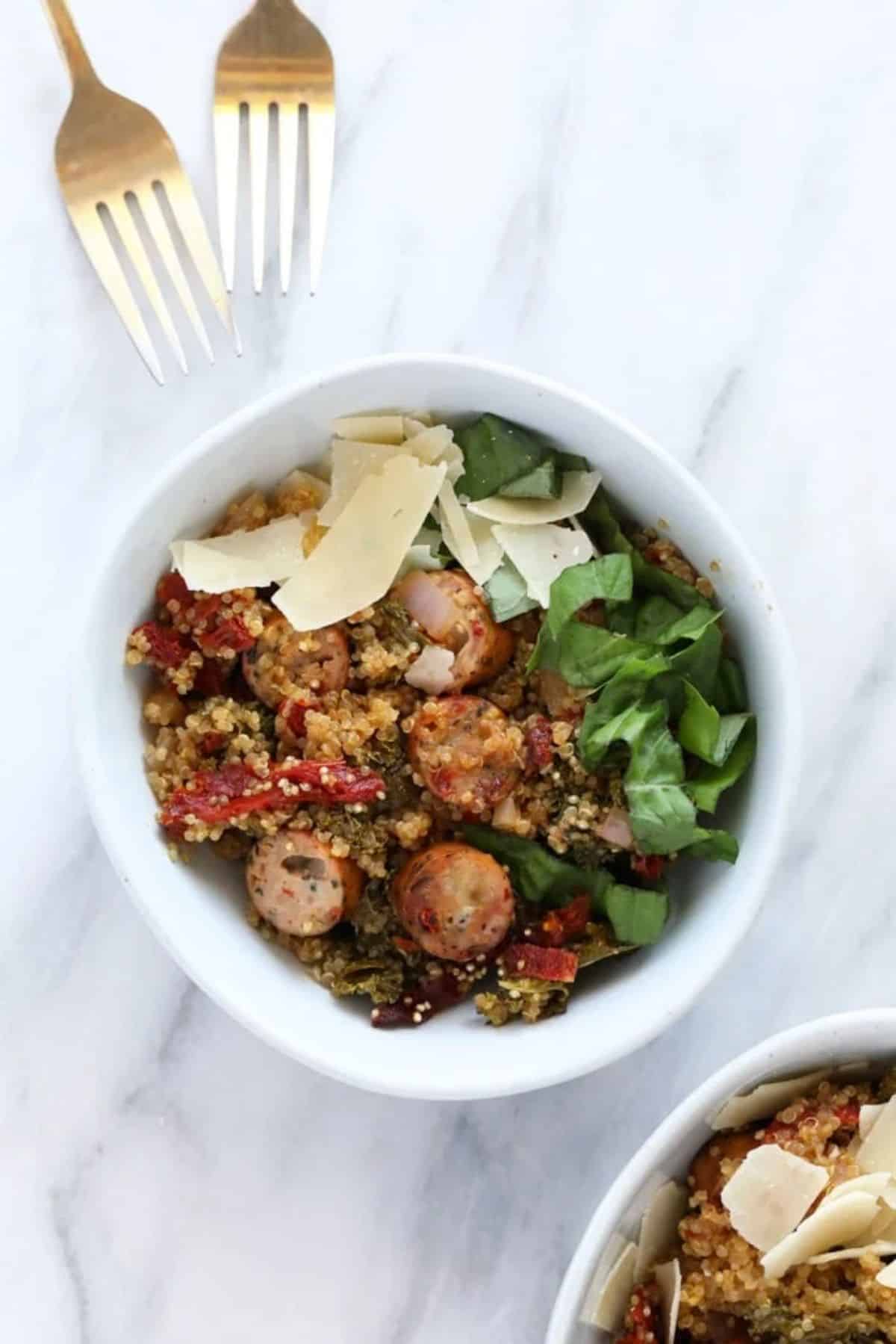 Scrumptious italian chicken sausage quinoa in a white bowl.