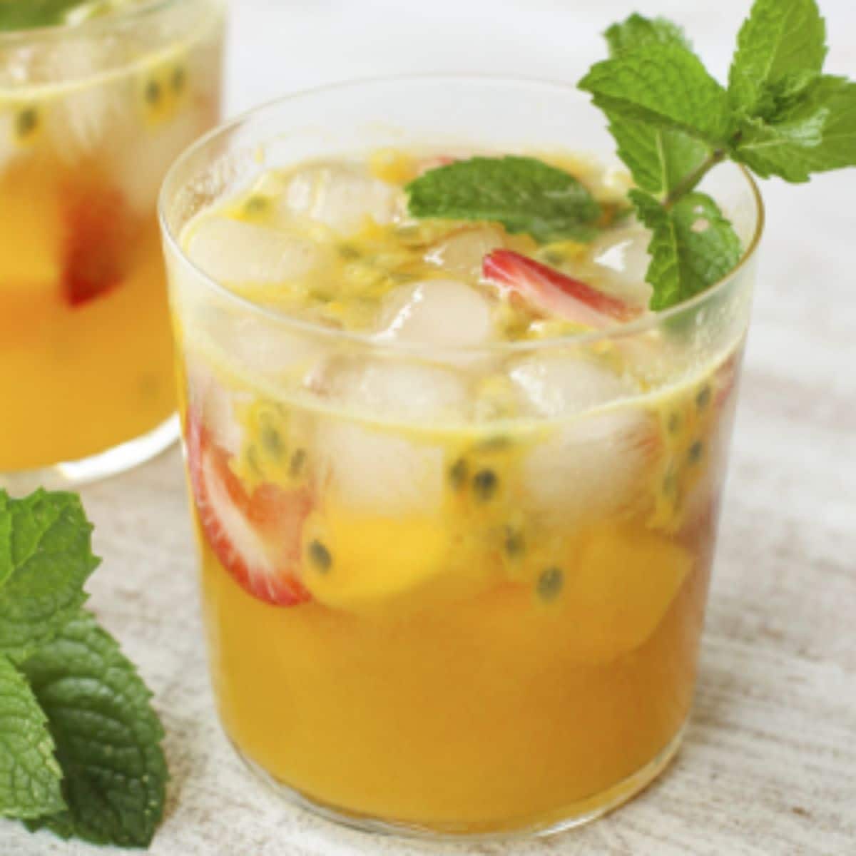 Delicious tropical sangria with passion fruit in a glass cup.