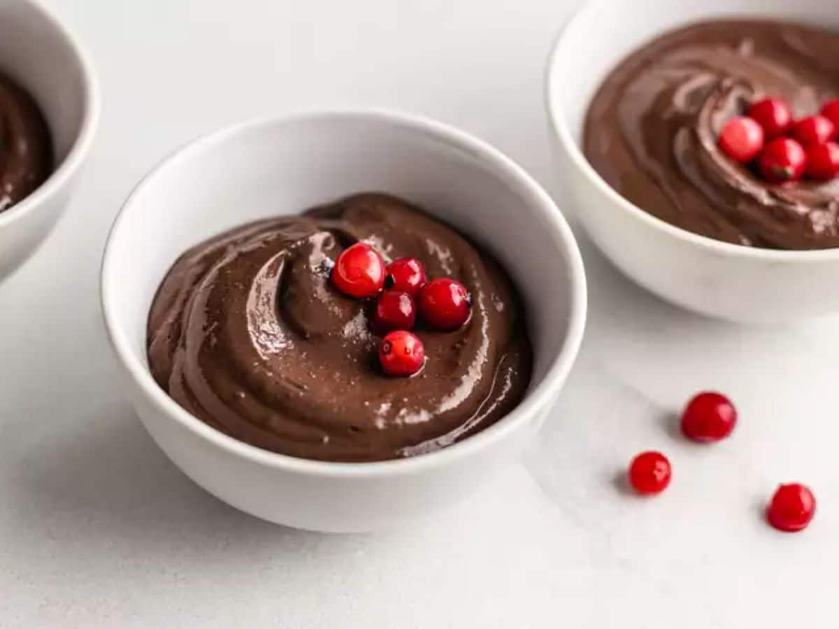 Creamy silken tofu chocolate mousse with dates in white bowls.