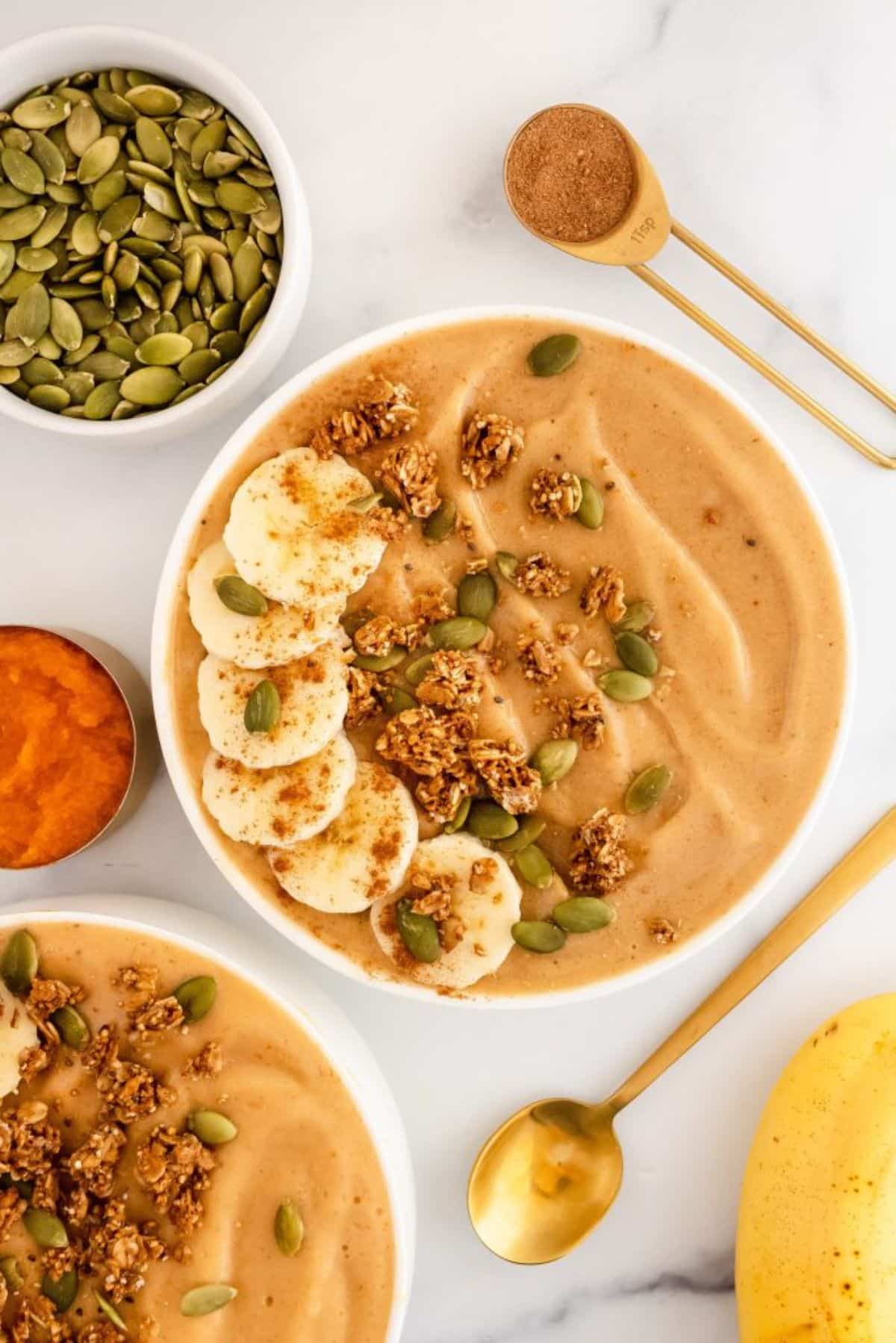 Delicious pumpkin smoothie bowl on a countertop.