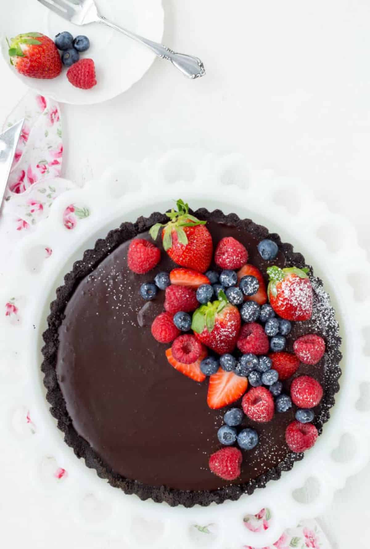 Mouth-watering no-bake chocolate tart on a cake tray.