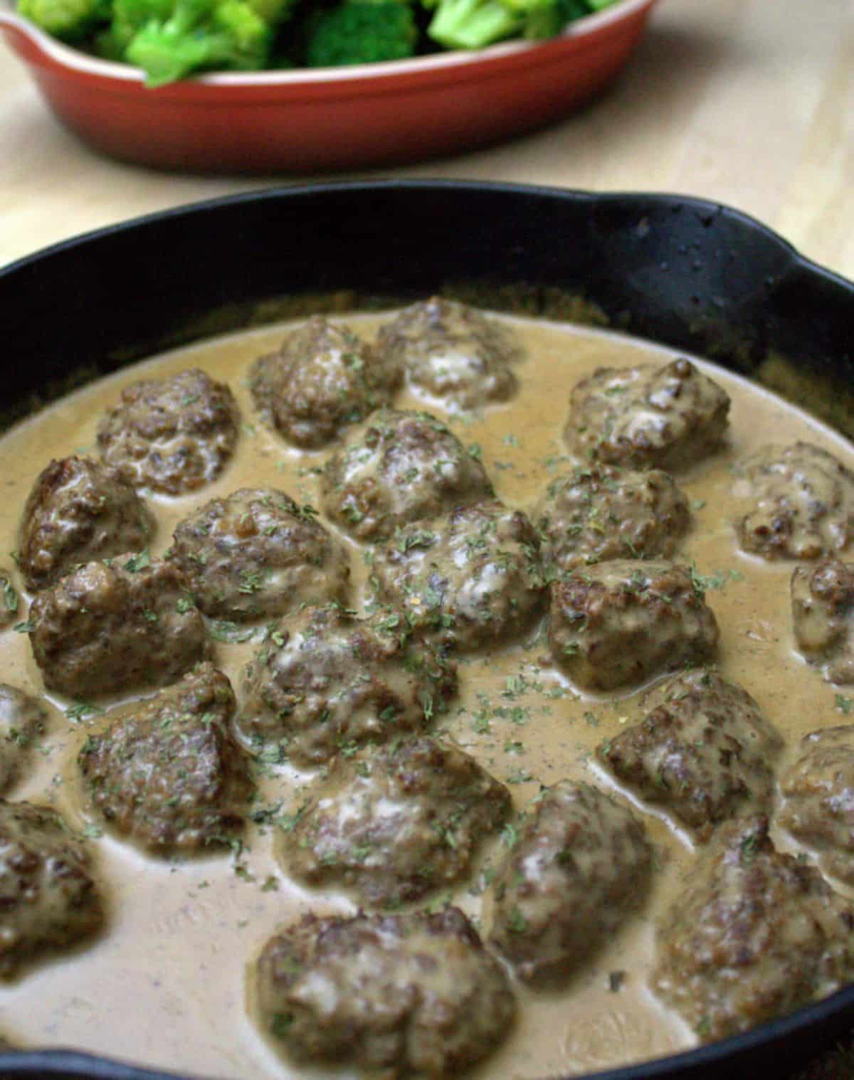 Delicious venison sweedish meatballs in a black skillet.