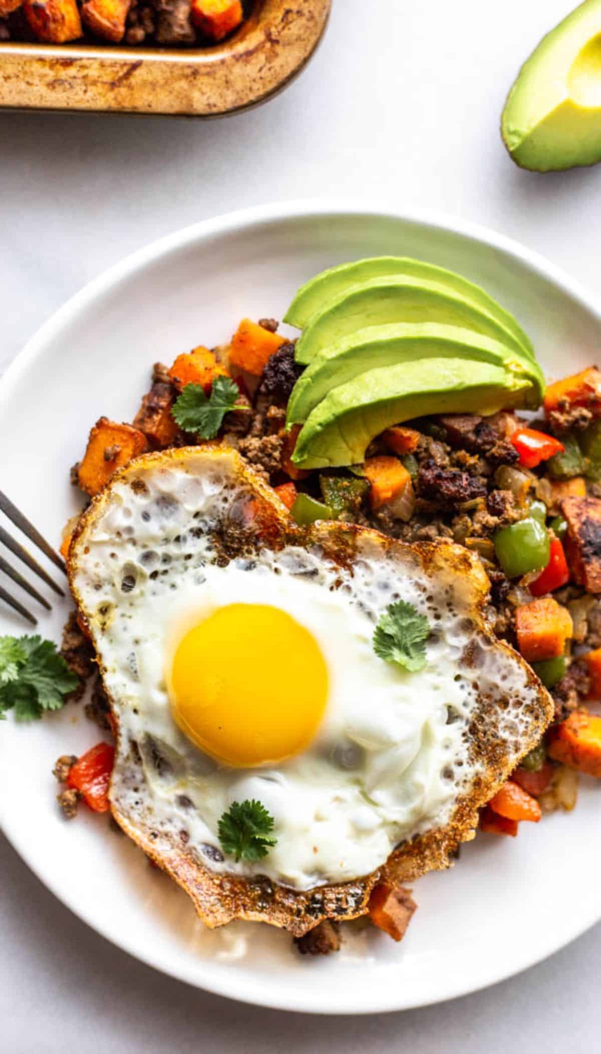 Healthy bison sweet potato hash on a white plate.