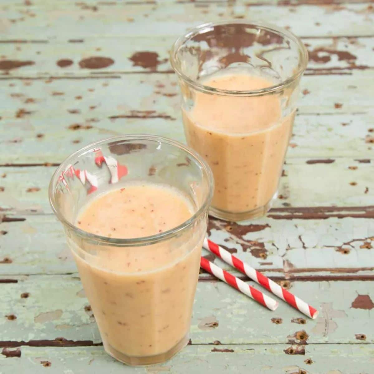 Healthy mango passion fruit smoothie in two glass cups.