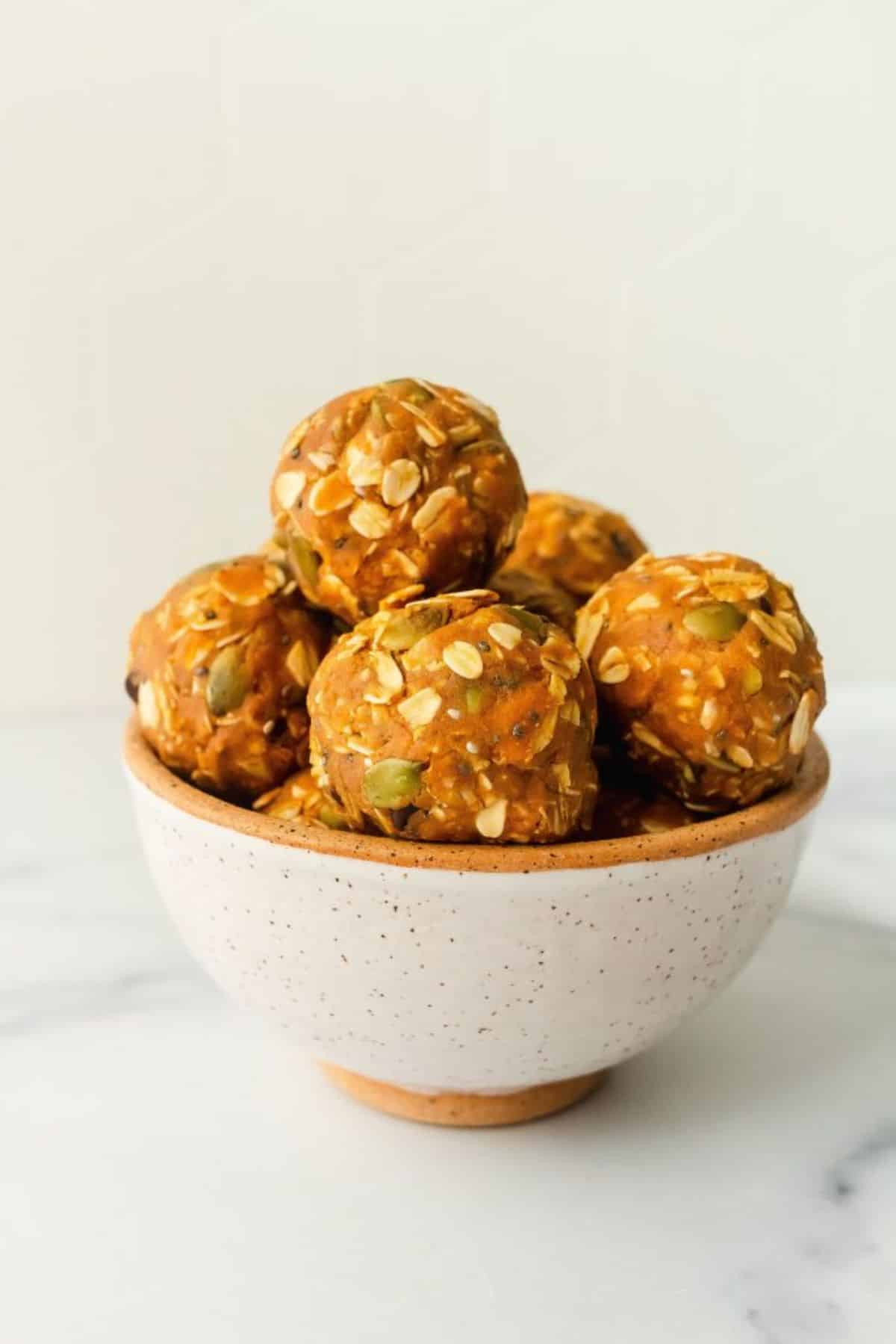 Healthy pumpkin cookie protein balls in a bowl.