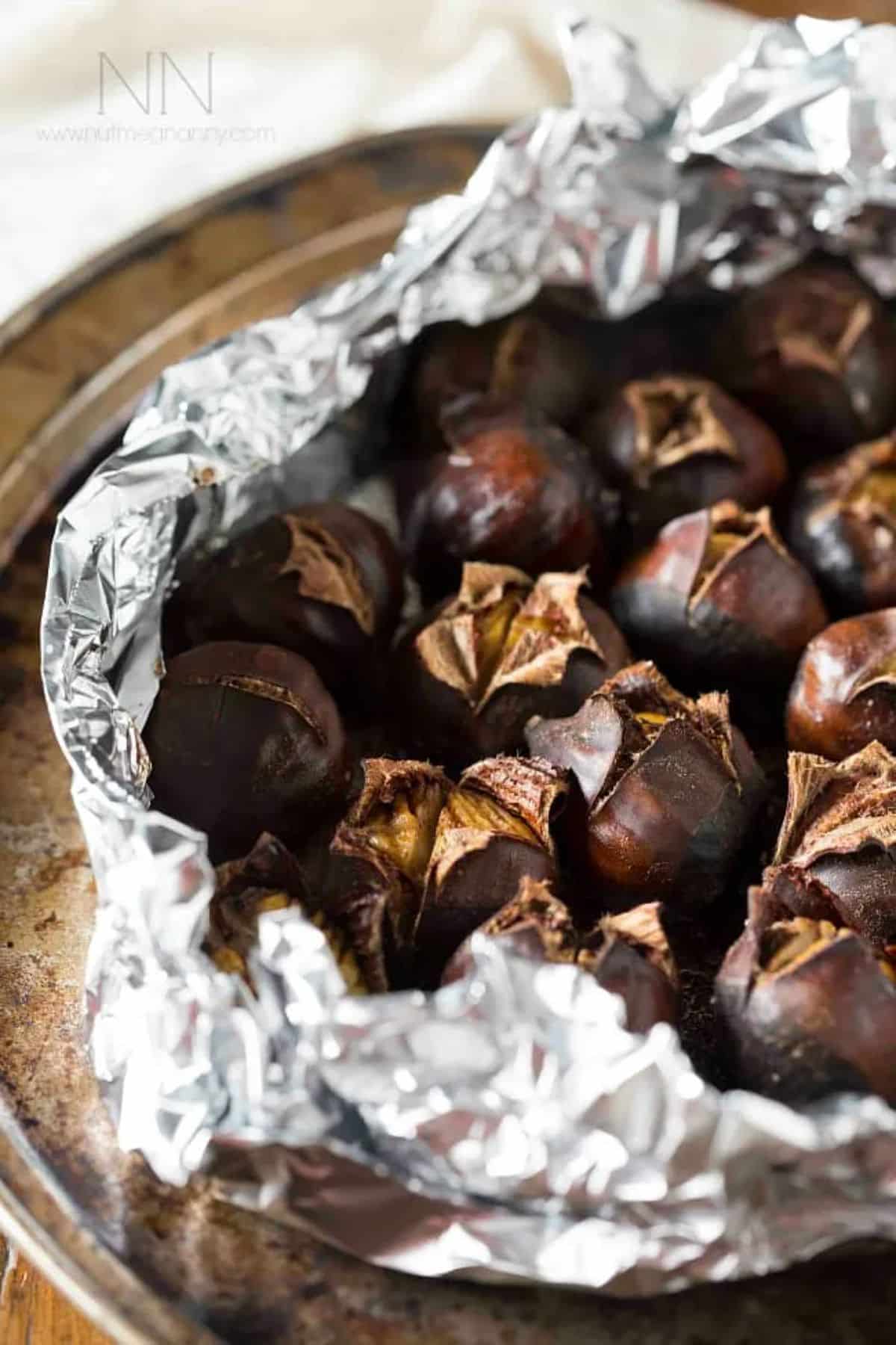 Crispy butter-roasted chestnuts on a tray.