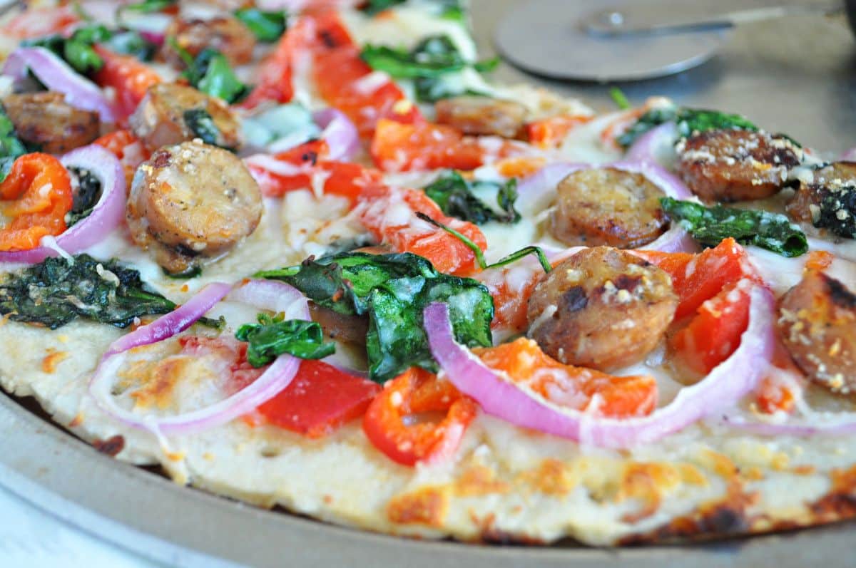 Scrumptious chicken sausage pizza on a tray.