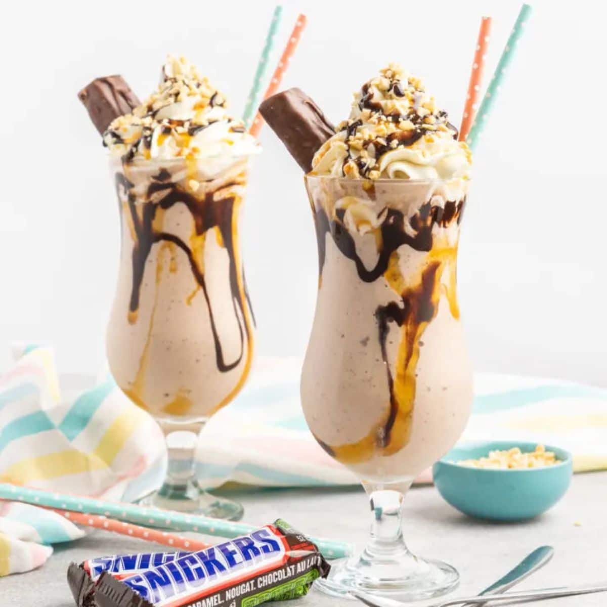 Mouth-watering easy snickers milkshake in tall glasses.