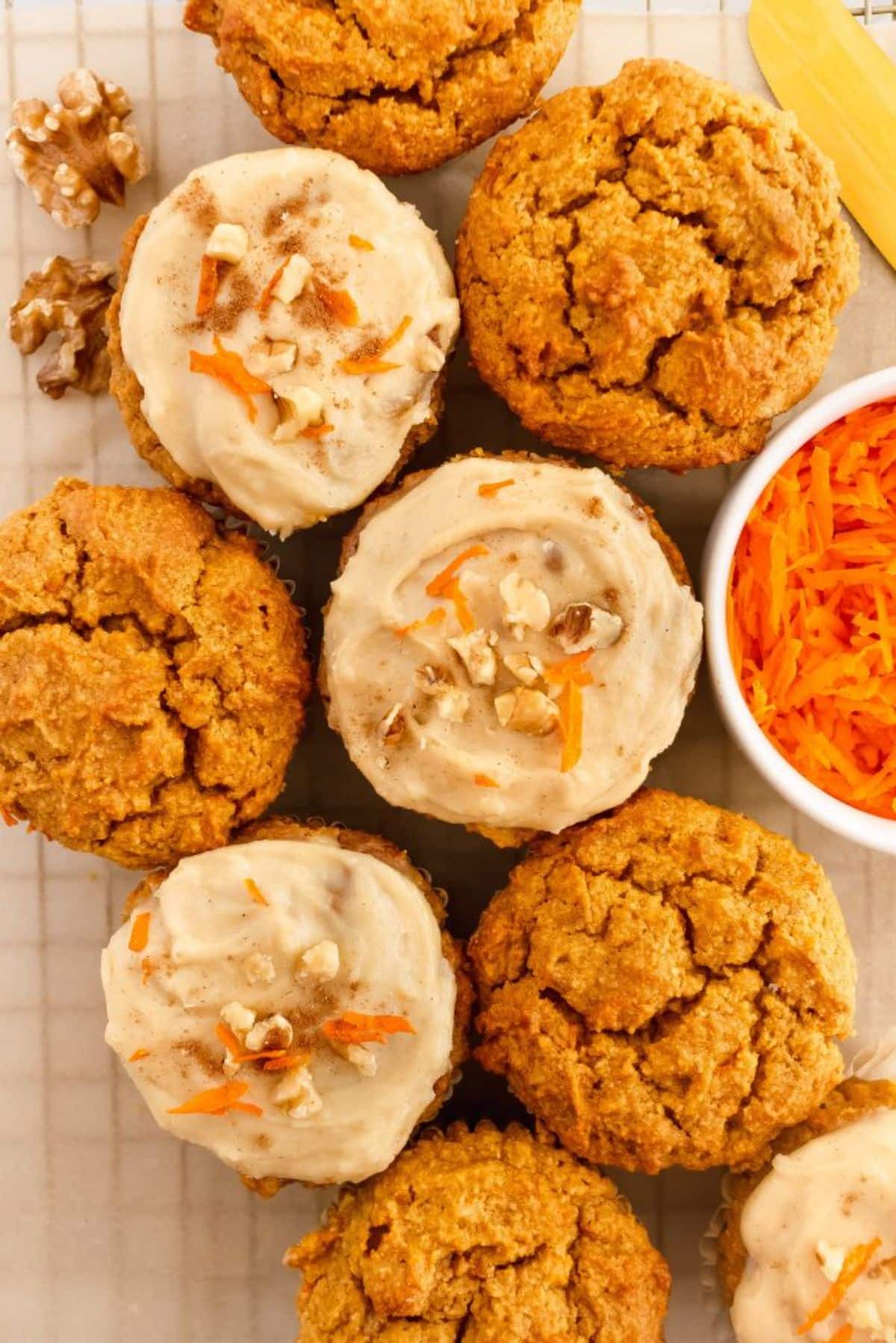 Flavorful gluten-free pumpkin carrot muffins on a resting grid.