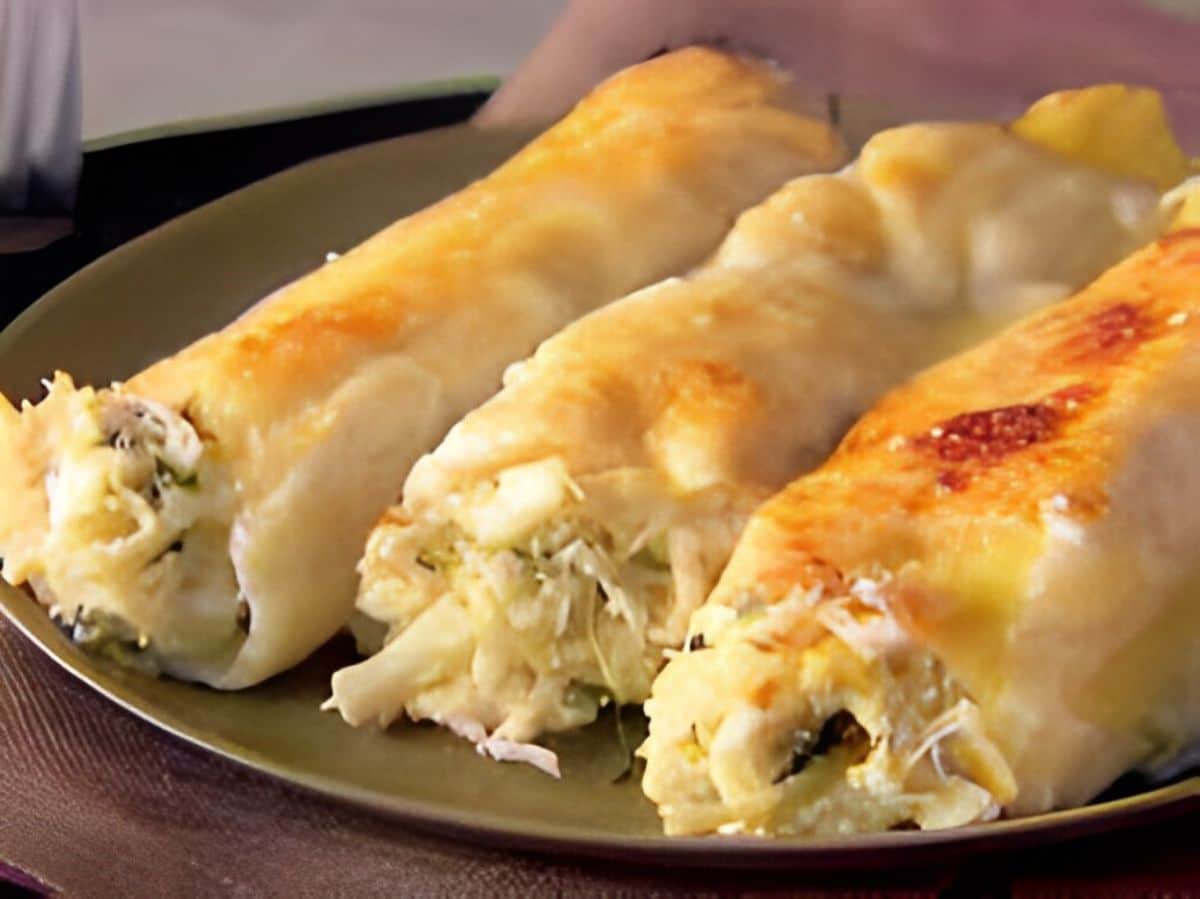 Tasty crab and ricotta cannelloni on a gray tray.