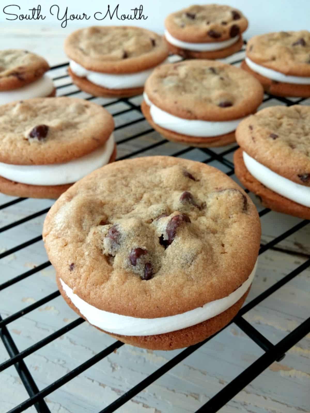 Fresh cookie sandwiches on a resting grid.