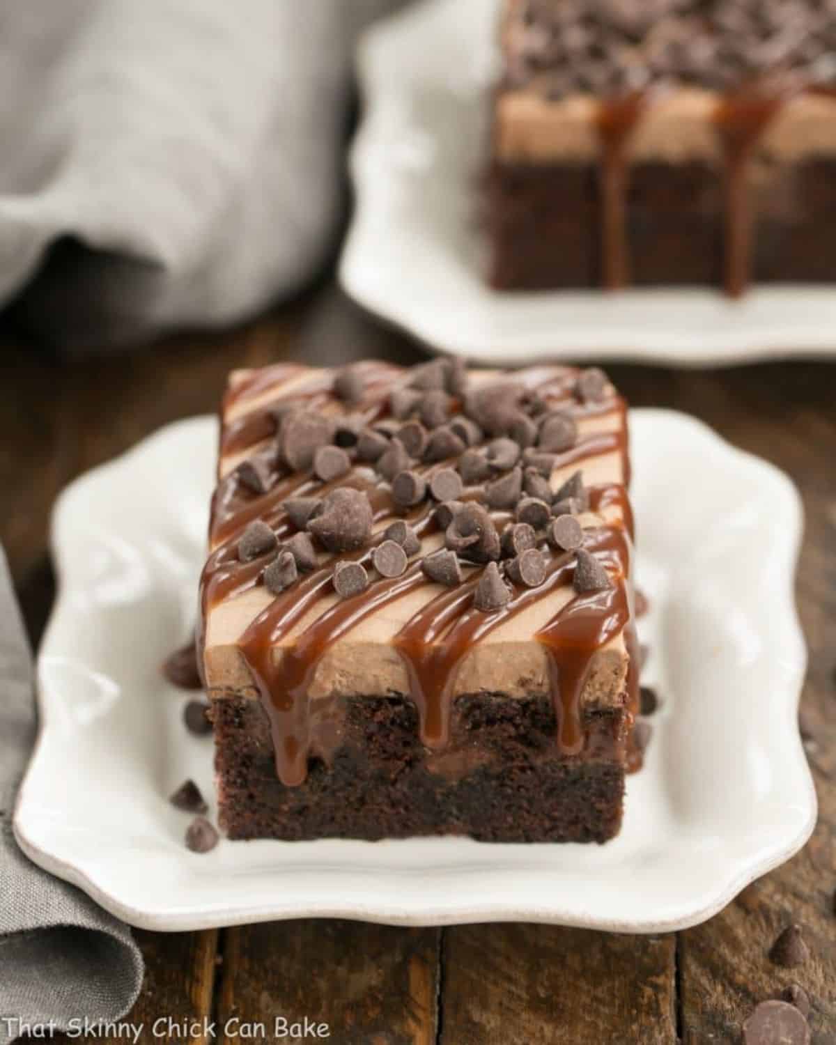 A piece of chocolate kahlua poke cake on a white plate.