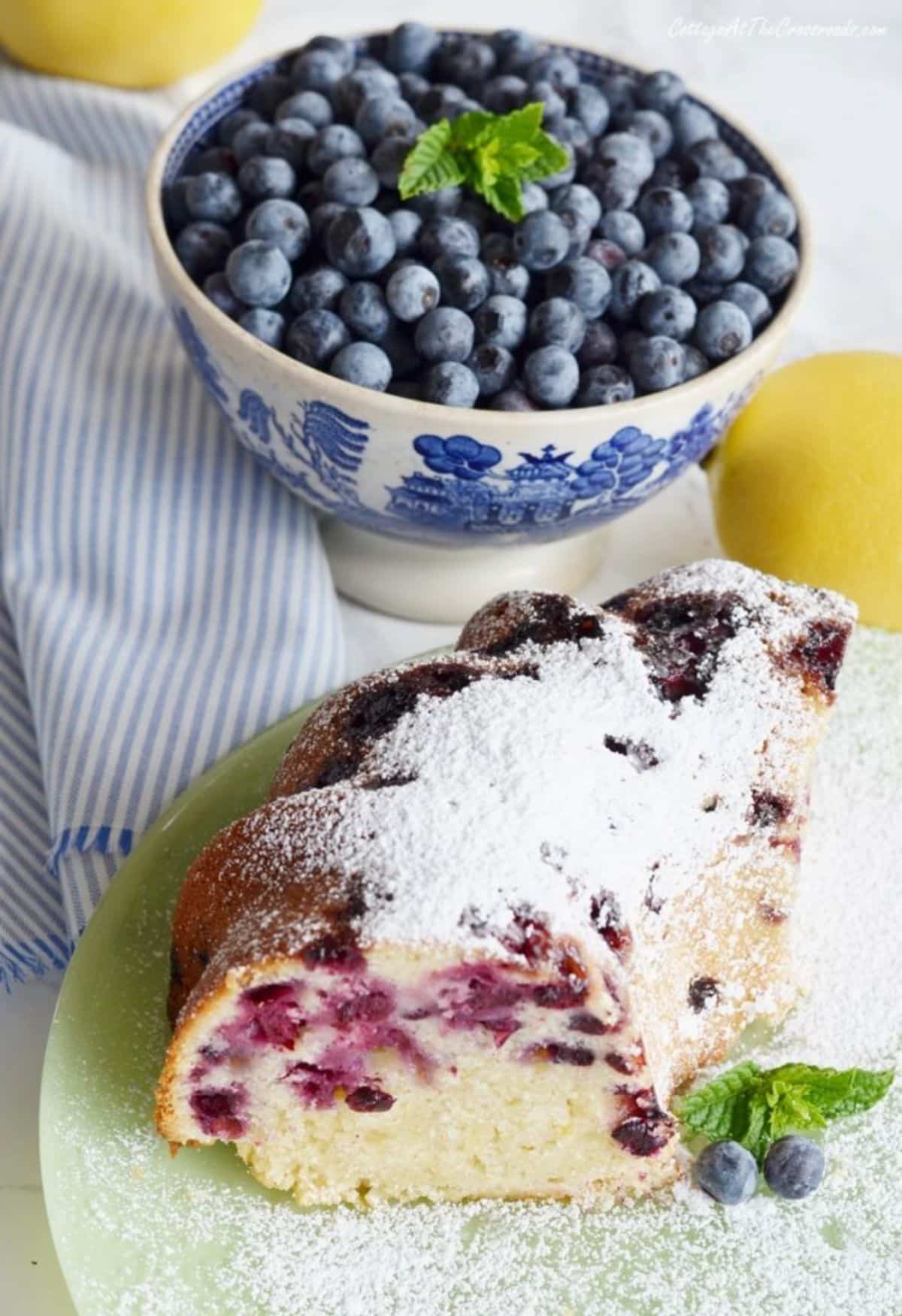 A piece of blueberry lemon pound cake on a cake tray.