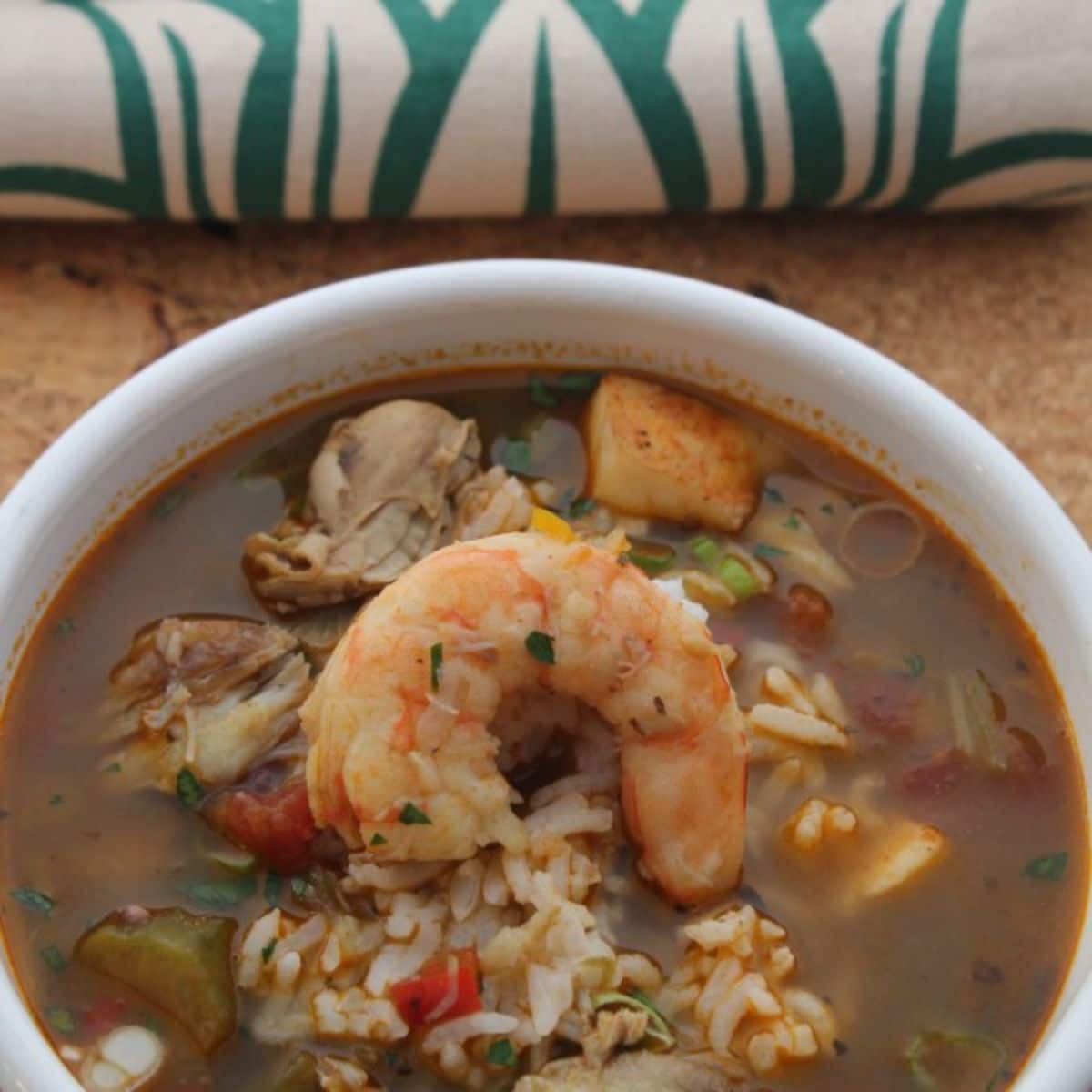 Healthy seafood gumbo in a white bowl.