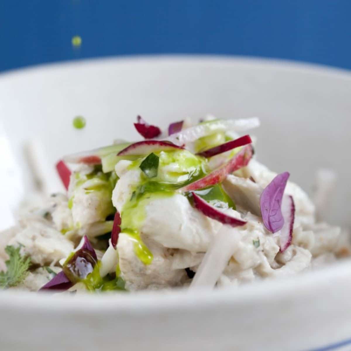 Fresh turnip and radish slaw in a white bowl.