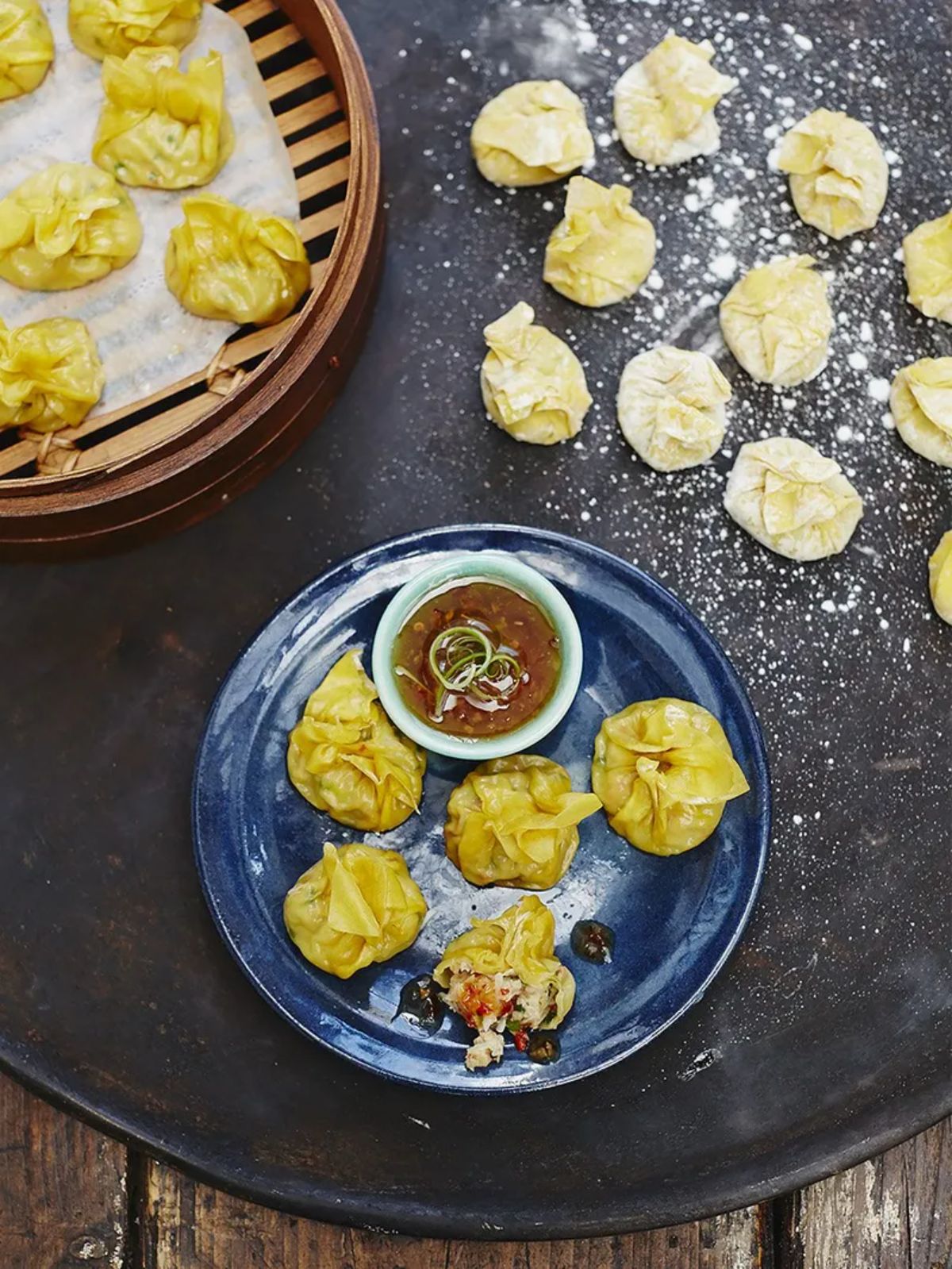 Tasty prawn and crab wontons on a black tray.