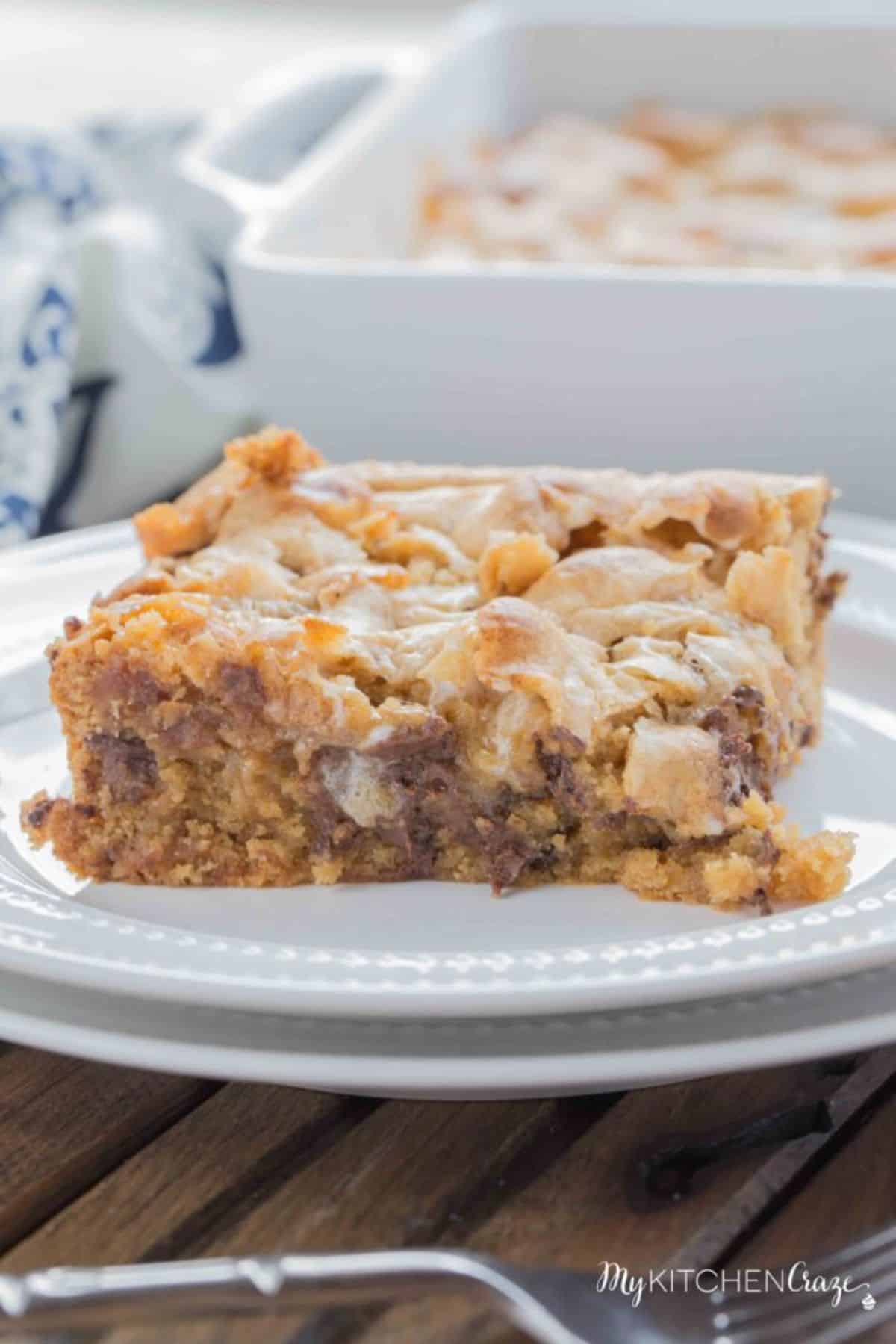 A piece of marshmallow blondies on a white plate.