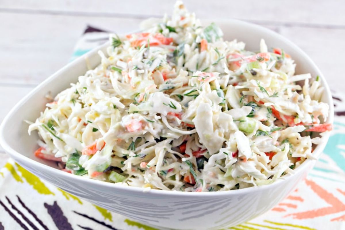 Healthy horseradish dill coleslaw in a white bowl.