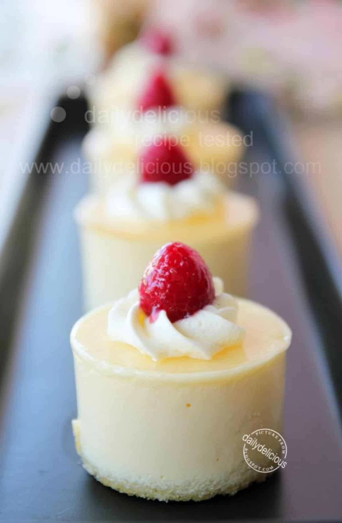Flavorful passion fruit mousse on a black tray.