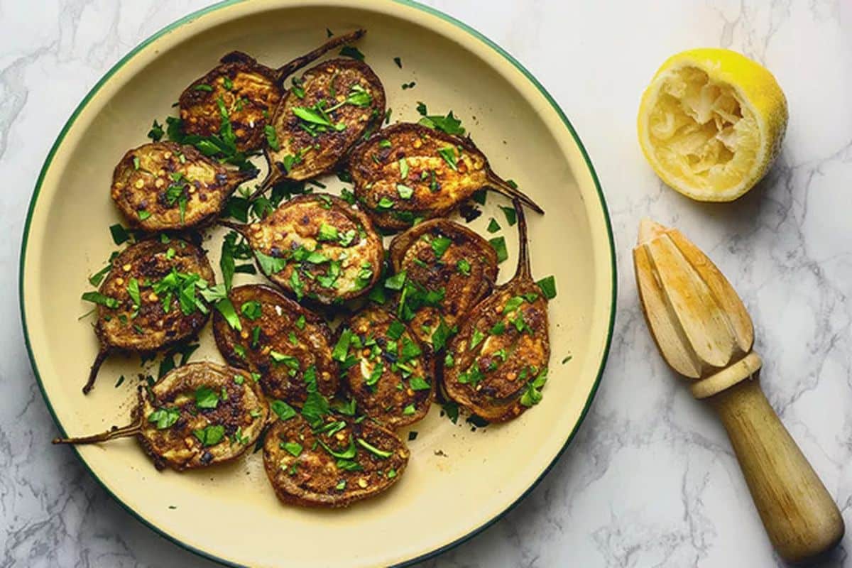 Flavorful spiced baby eggplants in a bowl.