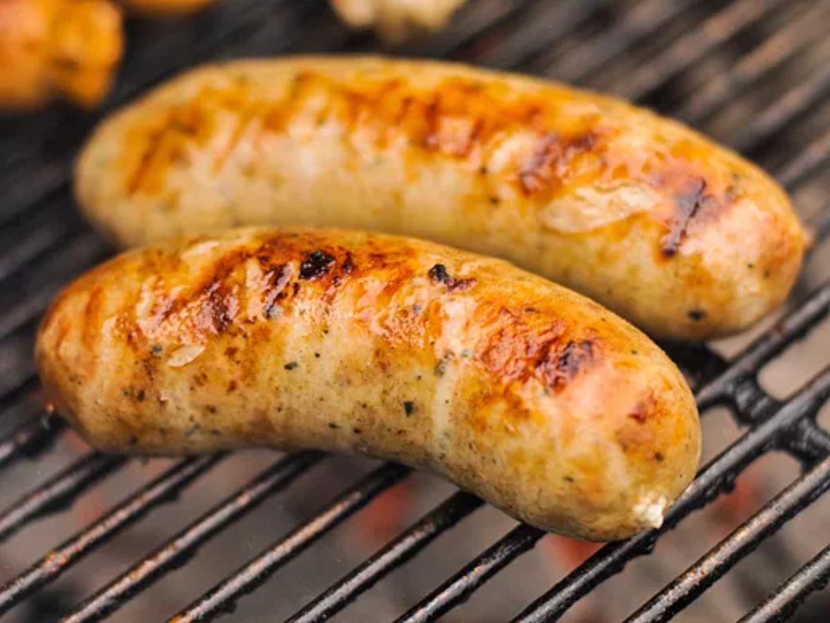 Scrumptious roasted garlic and feta chicken sausage in a grill.