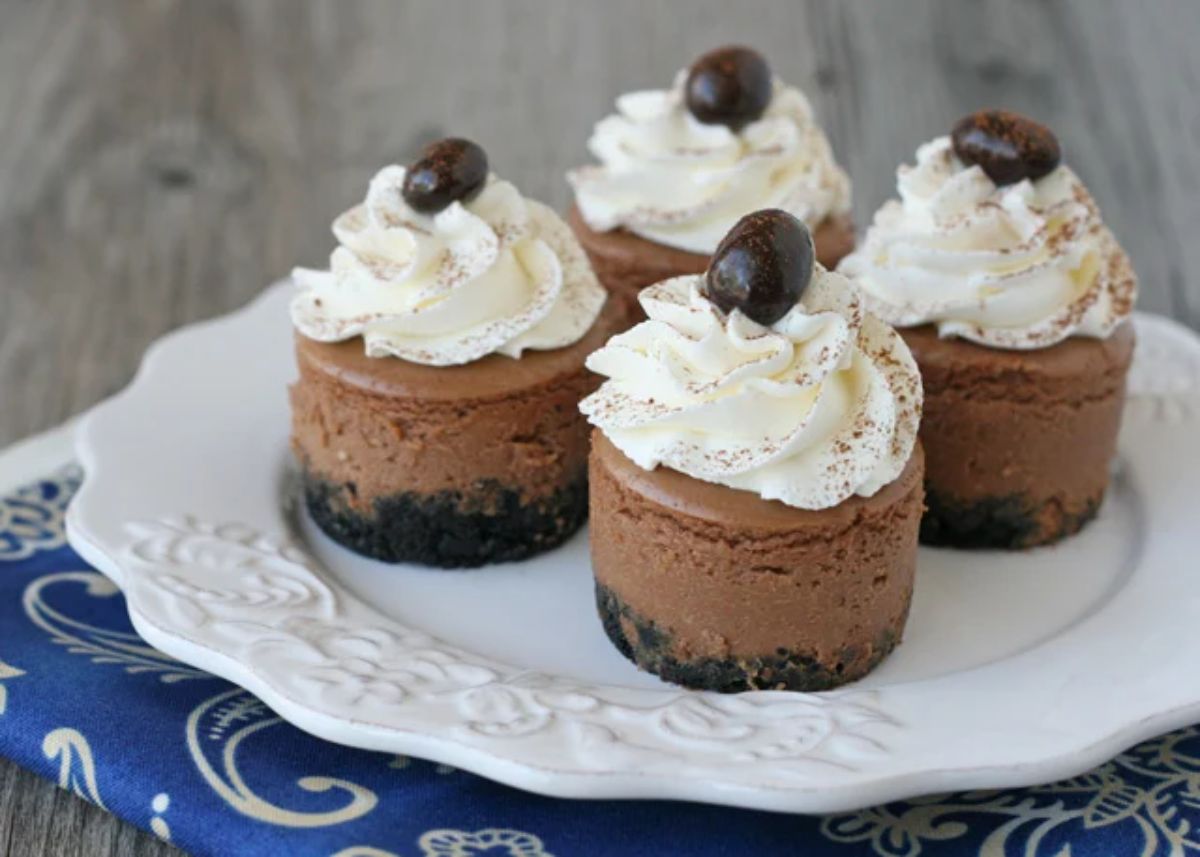 Delicious mini kahlua cheesecakes on a white plate.