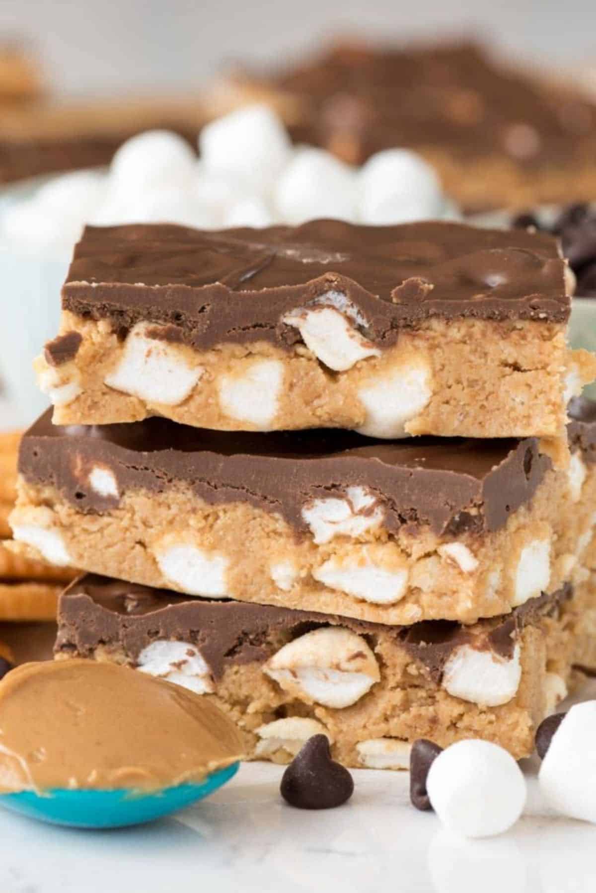 A pile of no bake s'mores peanut butter bars on a countertop.