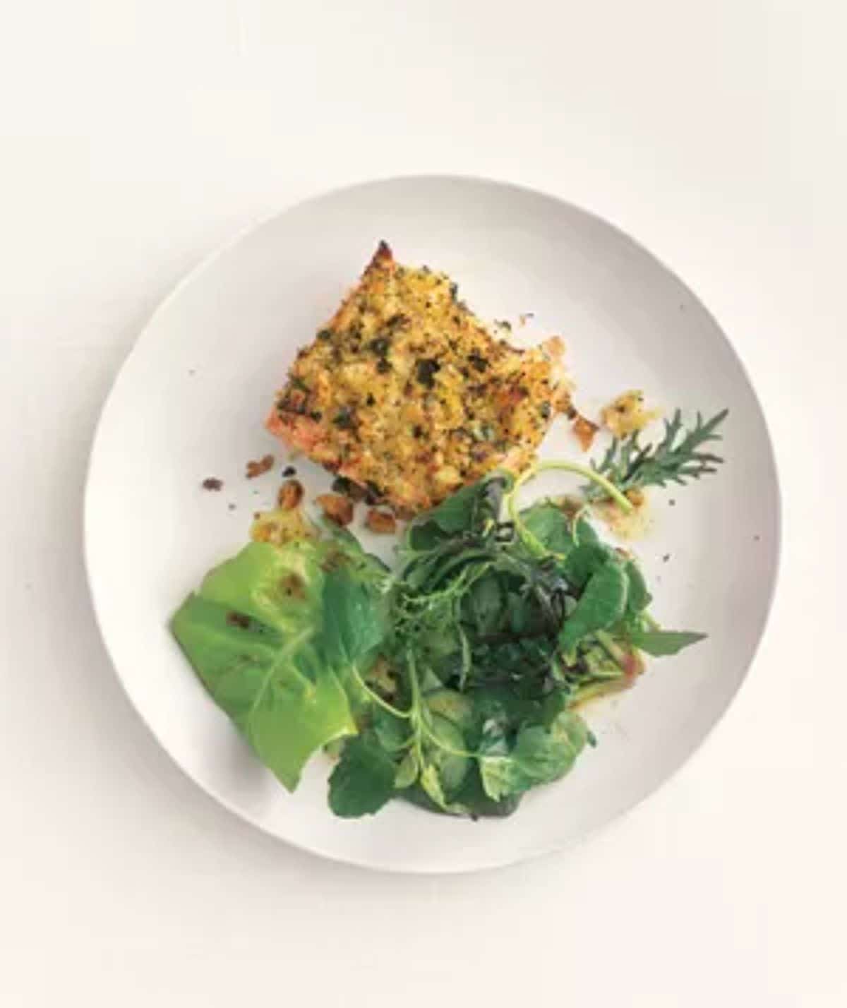 A piece of horseradish-crusted salmon on a white plate.