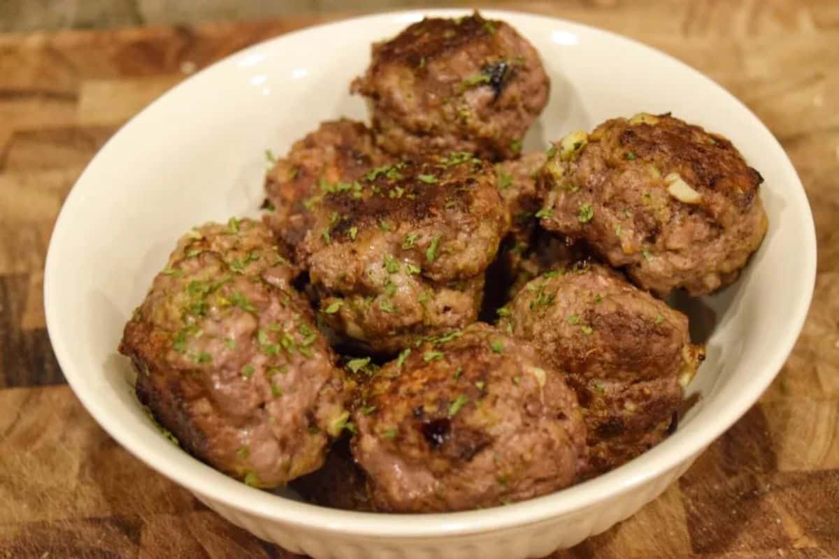 Healthy bison meatballs in a white bowl.