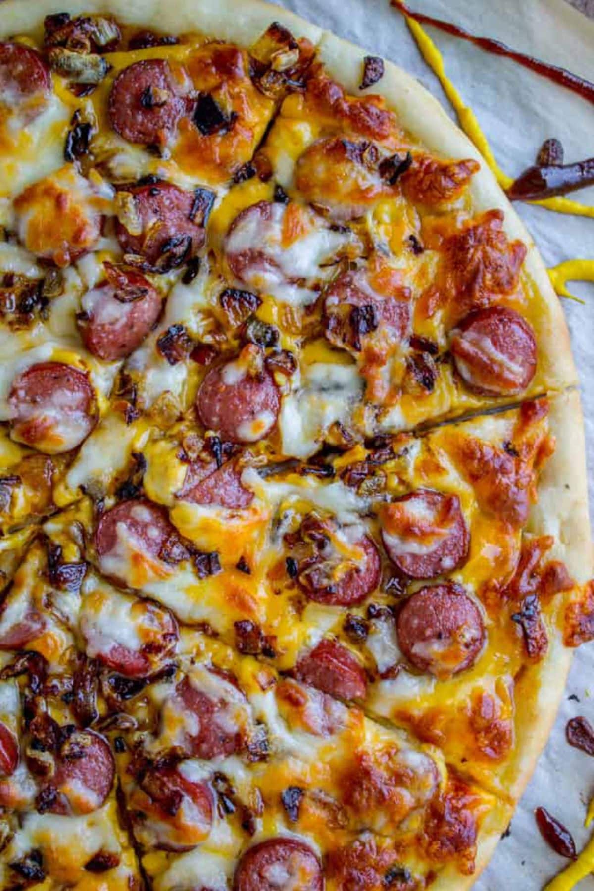 Flavorful hot dog pizza on a table.