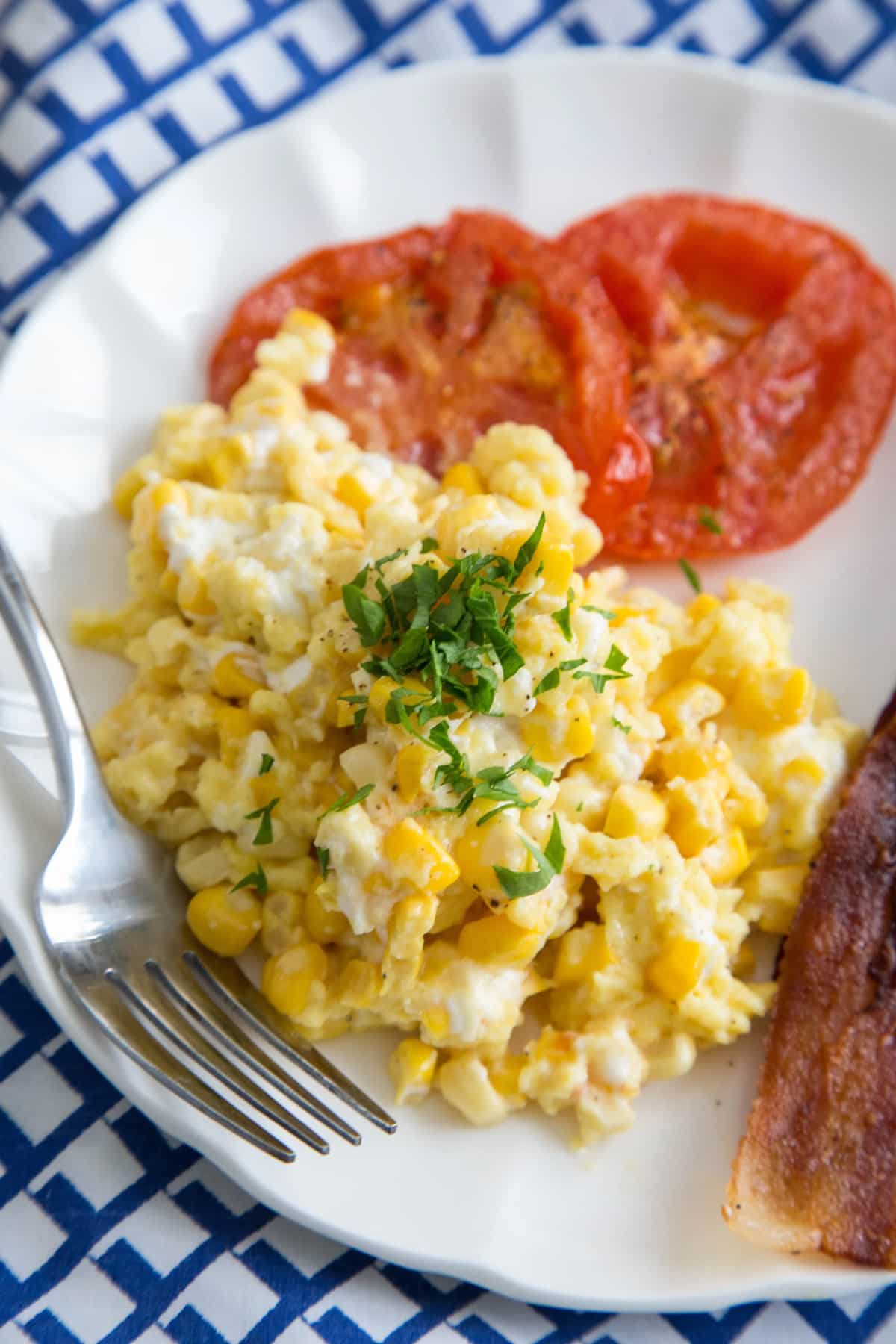 Scrambled eggs with fresh corn, goat cheese & tomatoes