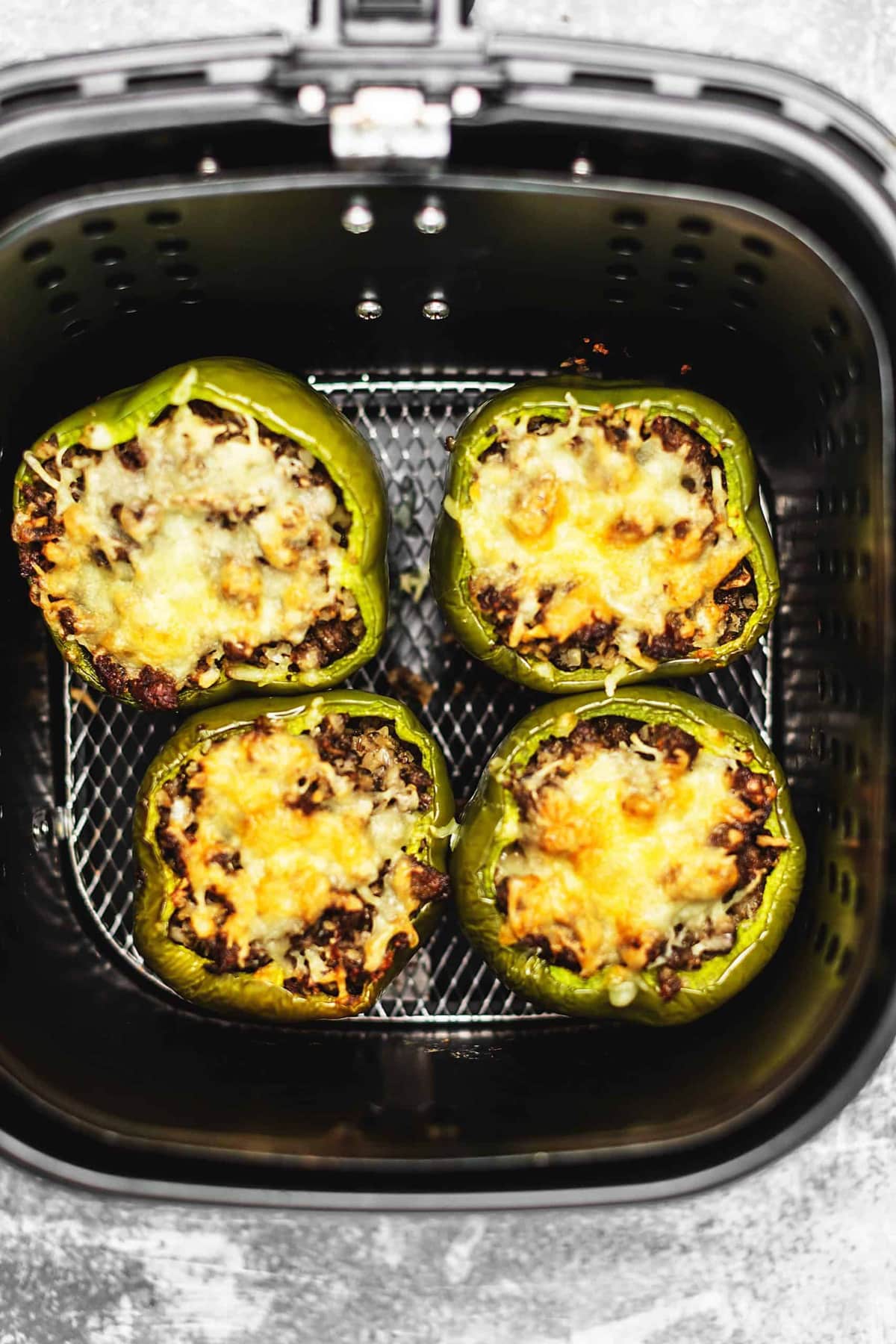 Air fryer stuffed peppers with italian sausage, cauliflower rice, mushrooms, and cheese