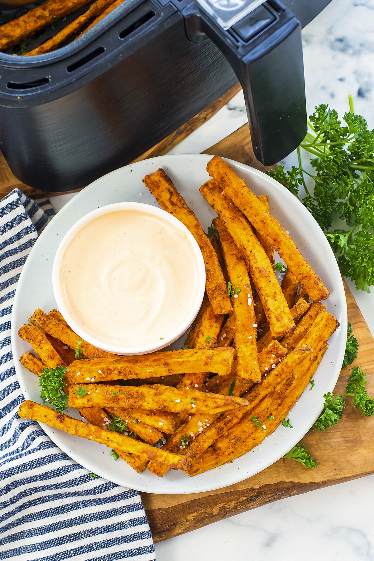 Crispy sweet potato fries in the air fryer with spicy dipping sauce